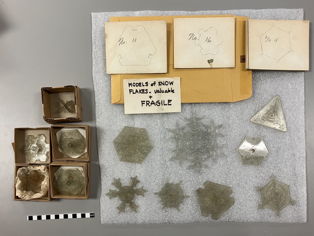 Collection of snow crystal models at the Nova Scotia Museum, plastic models and envelopes, a note that says "rare and fragile" 