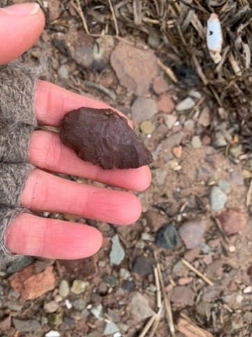 A person holding a stone.