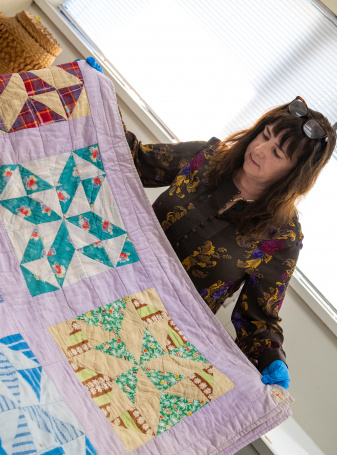 Lisa Bower, History Collections Assistant Curator and Registrar, working on quilts.