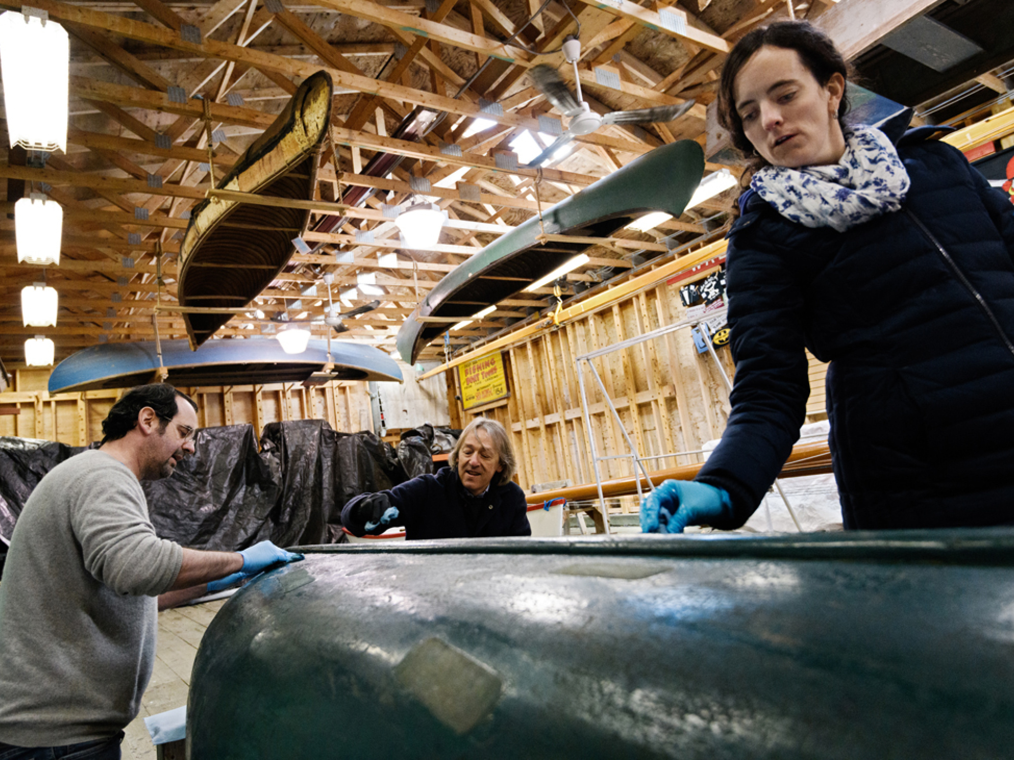Amber Laurie Curator of Marine History cleaning a canoe.