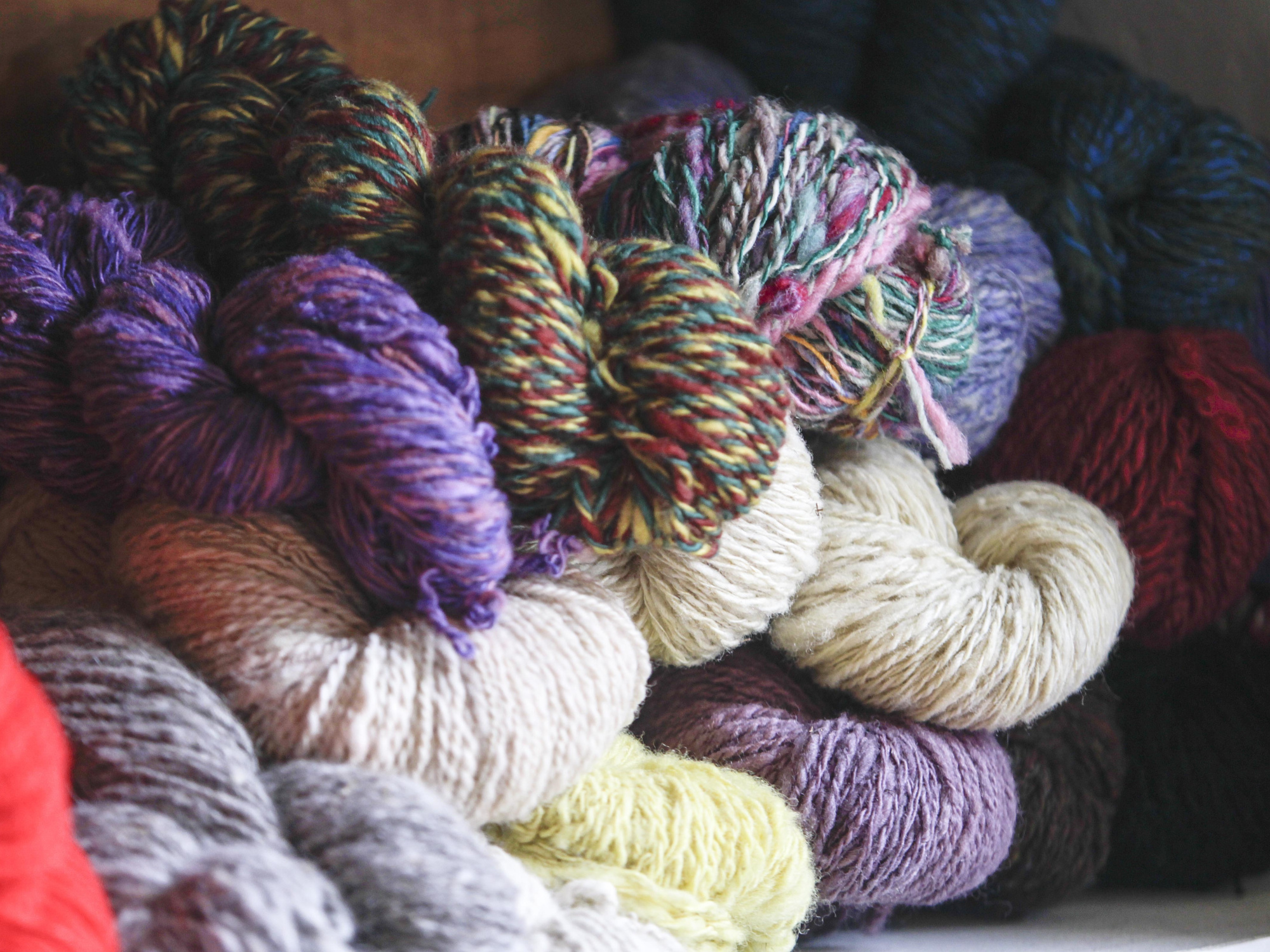 Skeins of wool in a pile.