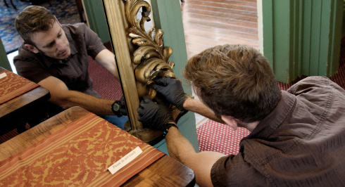 Senior conservator working on a framed mirror at Clifton Museum Park.