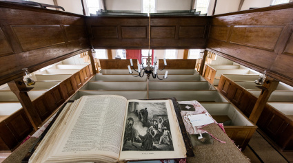 Book resting on a podium overlooking a historic meeting room