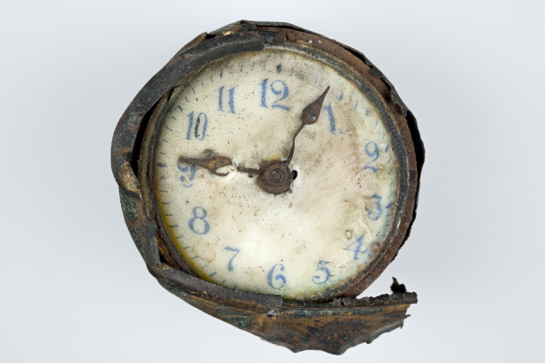 Clock found in explosion wreckage, front.