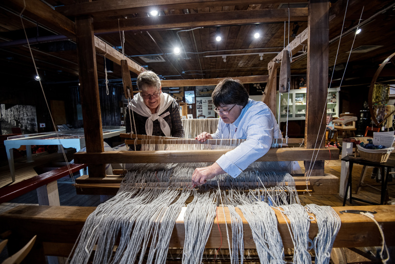 Fisheries Museum of the Atlantic interpreters working on a loom.