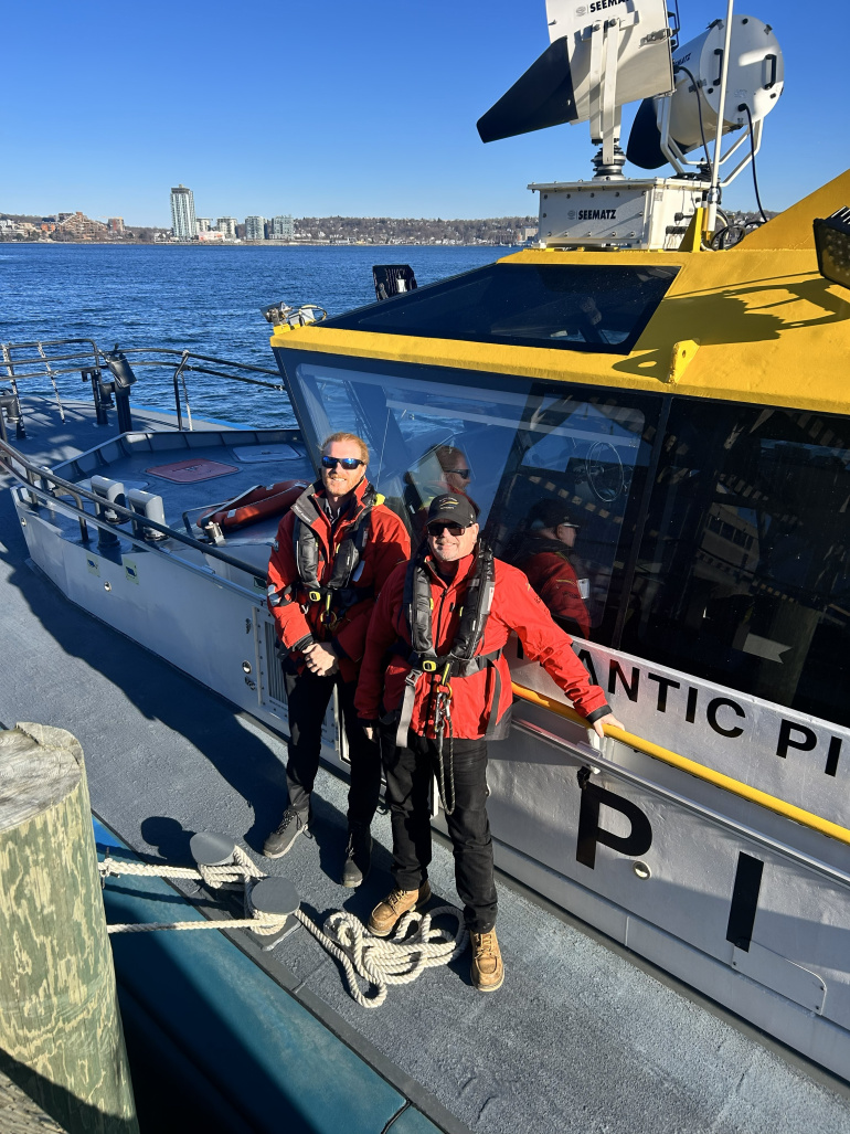 Ross Macfadden & Ian Wallace standing on a wharf.
