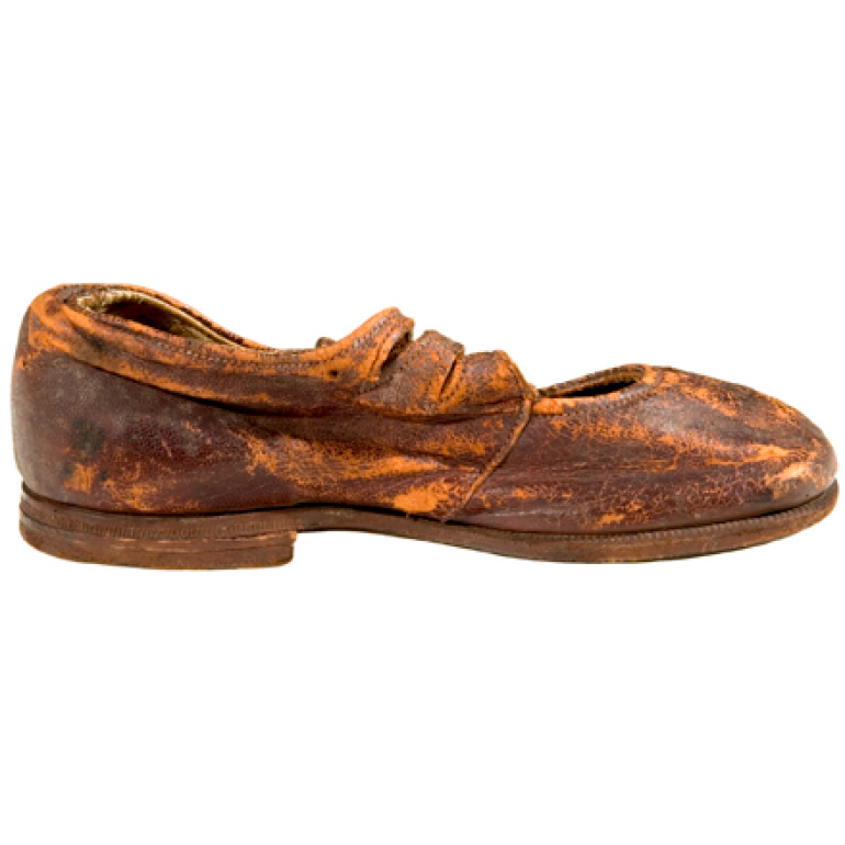 side view of a leather children’s shoe is believed to be from Body No. 4, the “Unknown Child”