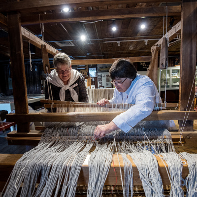 Fisheries Museum of the Atlantic interpreters working on a loom.