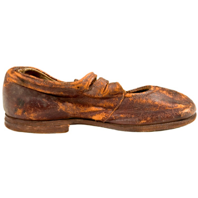 side view of a leather children’s shoe is believed to be from Body No. 4, the “Unknown Child”