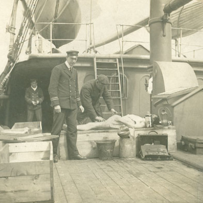A Titanic victim is embalmed aboard the cable ship Minia.