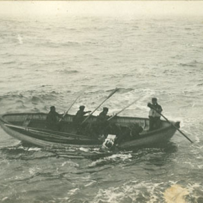 : A boat crew from the Cable Ship Minia picks up one of the Titanic victims. Recovery was hard, grim work, amidst large waves and dangerous ice floes. Crews were paid double and given extra rum rations.