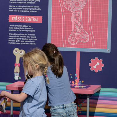 Girls explore an interactive station in the Mighty Engine exhibit.