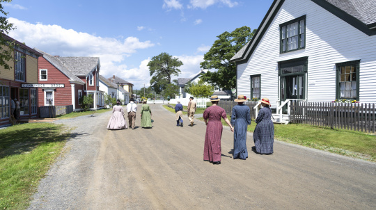 People in costume walking through Sherbrooke Village.