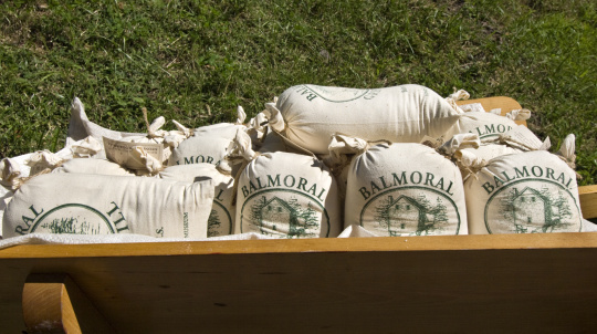 Wheelbarrow filled with bags of Balmoral Grist mill flour.