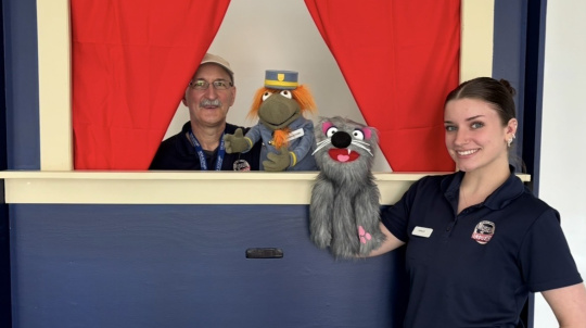 Staff using a Puppet Theater.