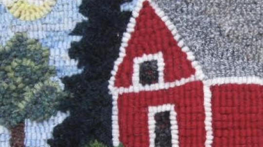 Rug hooking of a red barn.